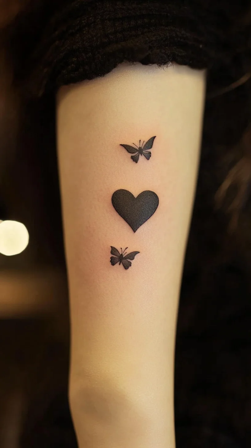 Elegant Black Ink: Minimalist Heart & Butterfly Tattoo for a Chic Statement